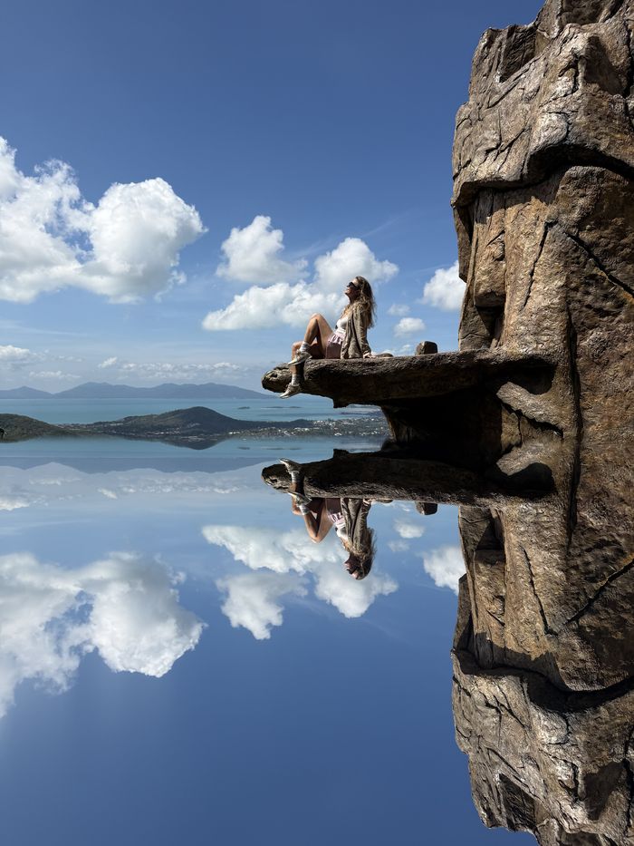 Sitting on a rock ledge above a mirror-still infinity pool looking over the Koh Samui coast