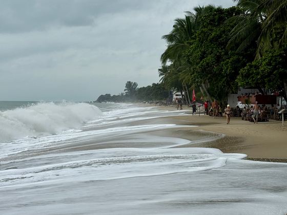 Waves breaking on a Koh Samui beach on a grey, windy day
